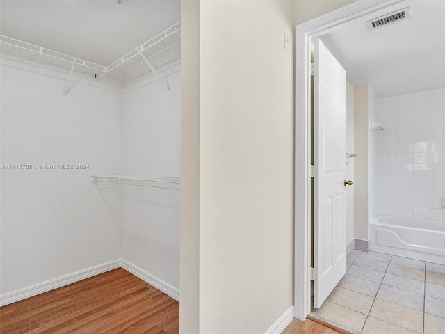 walk in closet with light tile patterned flooring