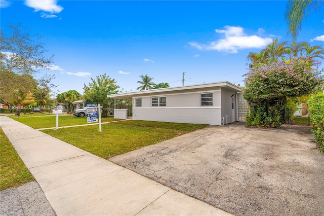 single story home featuring a front yard