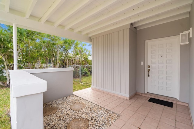 view of exterior entry featuring a patio area