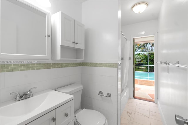 full bathroom with toilet, vanity, tile walls, and shower / bath combo
