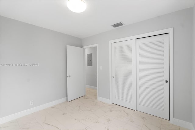 unfurnished bedroom with a closet and electric panel