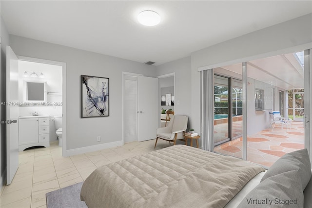 bedroom featuring access to outside, ensuite bath, a closet, and sink