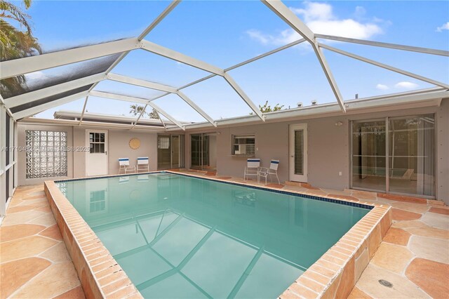 view of pool with a lanai and a patio