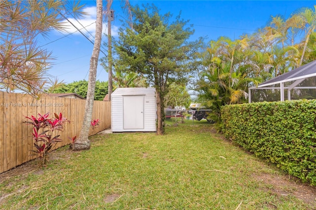 view of yard featuring a lanai and a storage shed