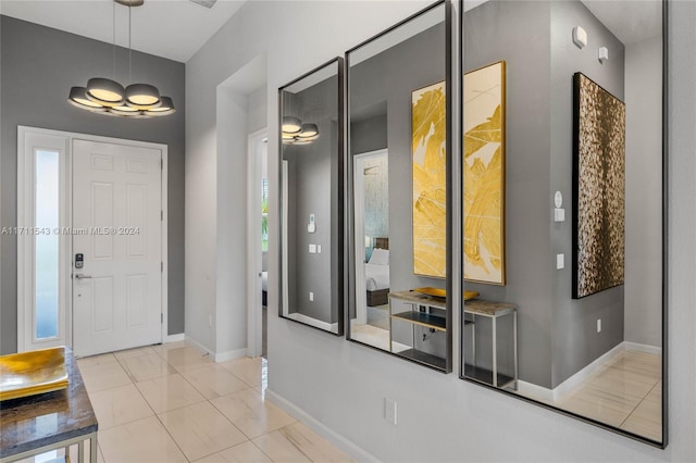 foyer with plenty of natural light and light tile patterned flooring