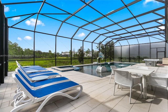 view of swimming pool featuring a lanai, an in ground hot tub, and a patio