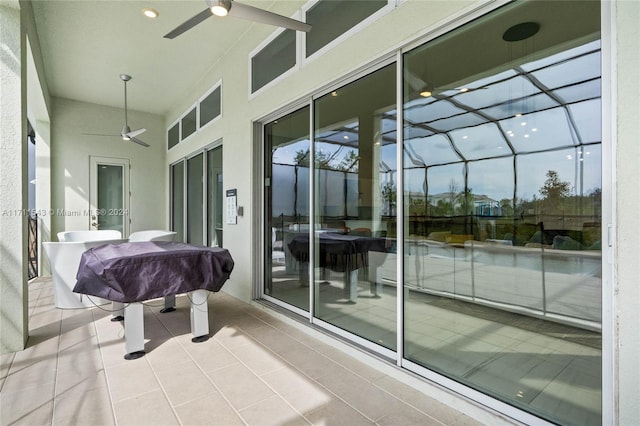 sunroom / solarium featuring ceiling fan