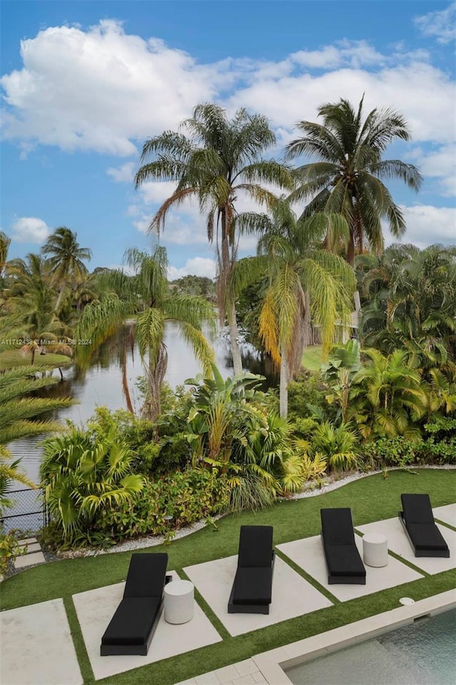 surrounding community featuring a patio and a water view