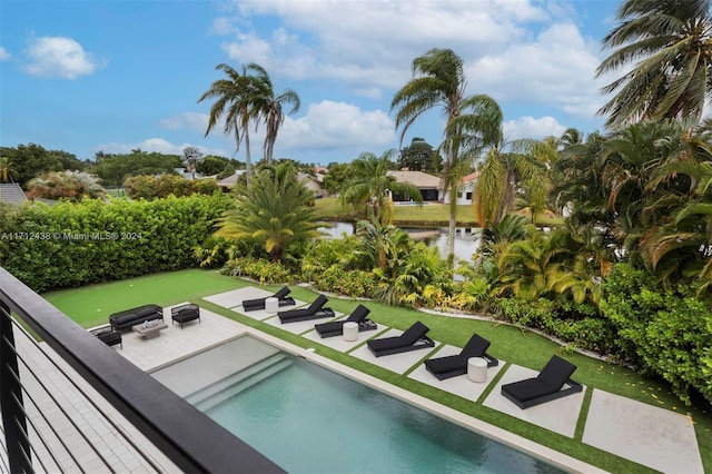 view of swimming pool featuring a water view