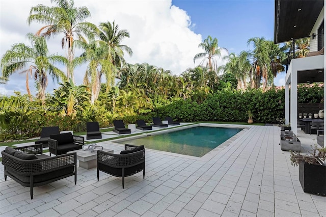 view of pool with a patio area and an outdoor living space