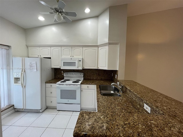 kitchen with white cabinets, dark stone countertops, white appliances, and sink