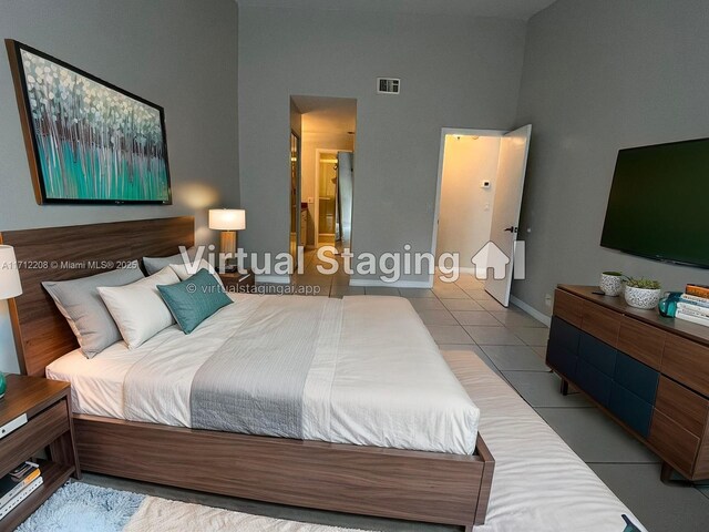 tiled bedroom featuring a towering ceiling