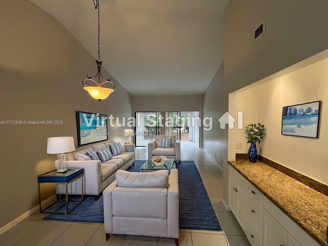 tiled living room with high vaulted ceiling