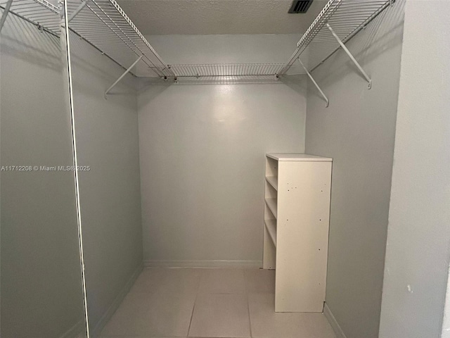 walk in closet featuring tile patterned floors