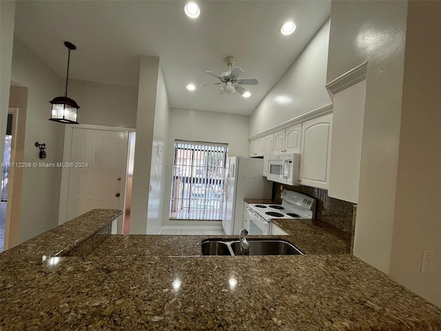 kitchen with white appliances, white cabinets, sink, hanging light fixtures, and ceiling fan