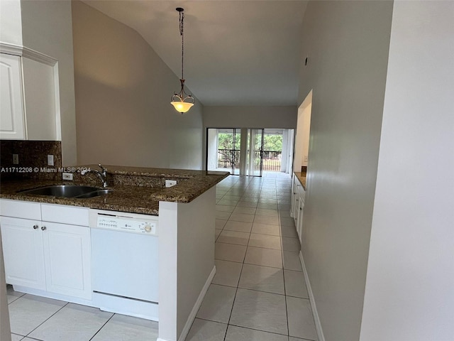 kitchen featuring white dishwasher, vaulted ceiling, sink, decorative light fixtures, and white cabinets