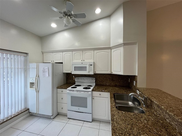 kitchen featuring white cabinetry, sink, ceiling fan, dark stone countertops, and white appliances