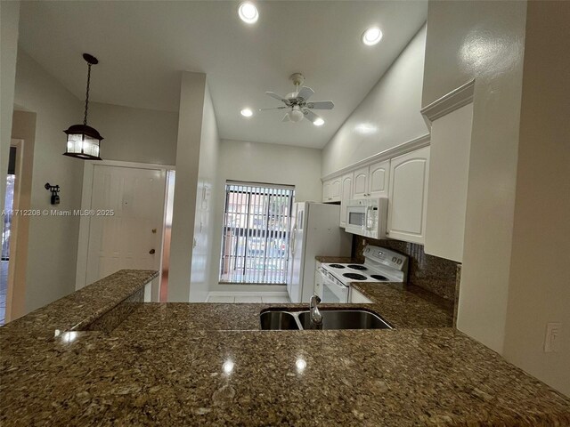 kitchen with sink, white cabinetry, hanging light fixtures, ceiling fan, and white appliances