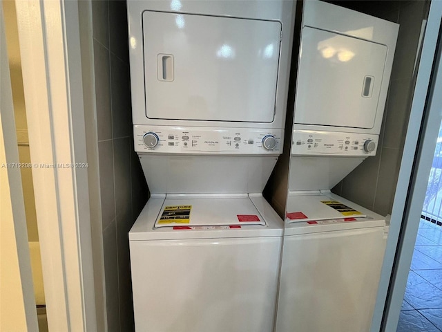 laundry area with stacked washer / dryer