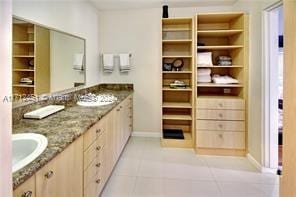 bathroom featuring tile patterned flooring and vanity