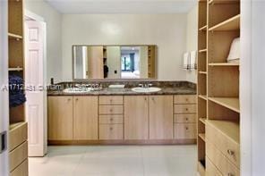 bathroom featuring tile patterned flooring and vanity