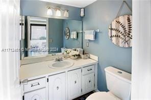 bathroom featuring vanity and toilet