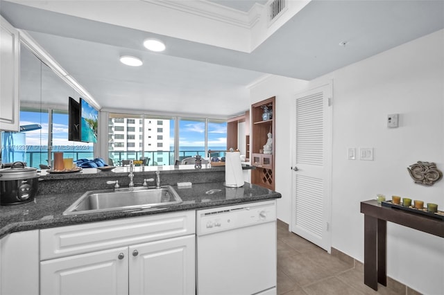 kitchen featuring white cabinets, dishwasher, plenty of natural light, and sink