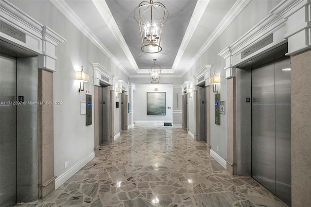 hallway with a notable chandelier, crown molding, elevator, and a tray ceiling