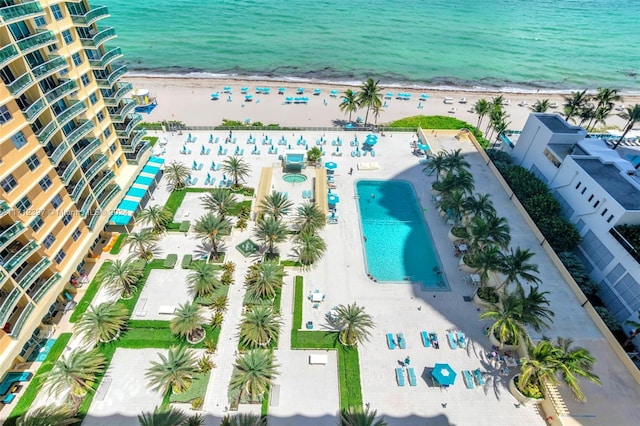 drone / aerial view with a water view and a beach view