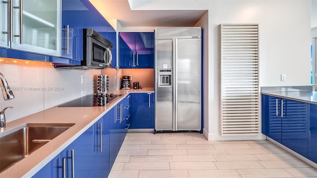 kitchen featuring blue cabinetry, appliances with stainless steel finishes, and sink