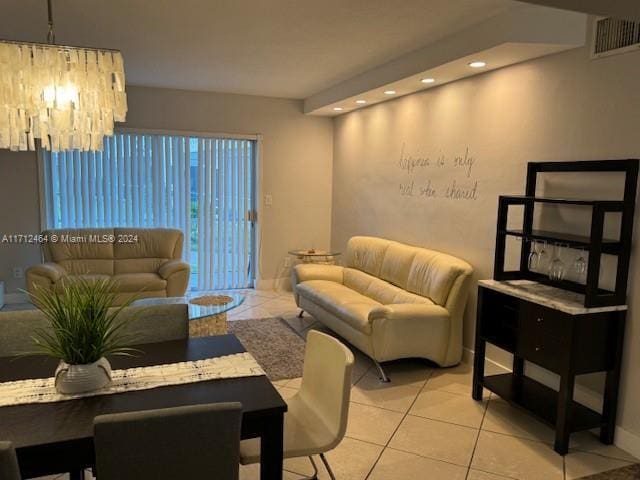 living room featuring light tile patterned floors and an inviting chandelier