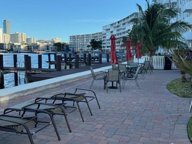 view of patio / terrace with a water view and a dock