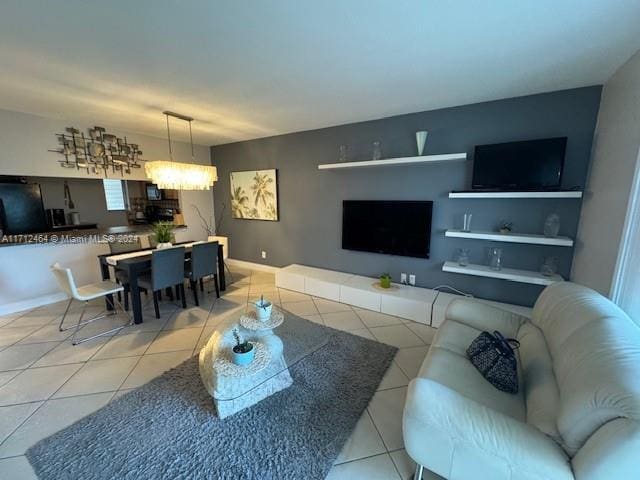 450 Golden Isles Dr Unit 1C, Hallandale Beach, FL 33009 - living room with tile patterned floors and a chandelier