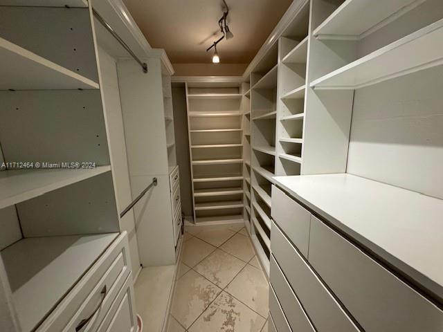 walk in closet featuring light tile patterned flooring