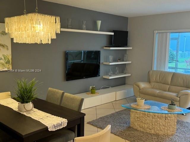 living room with tile patterned flooring and an inviting chandelier