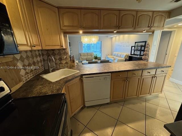 kitchen featuring black appliances, light tile patterned flooring, kitchen peninsula, and sink