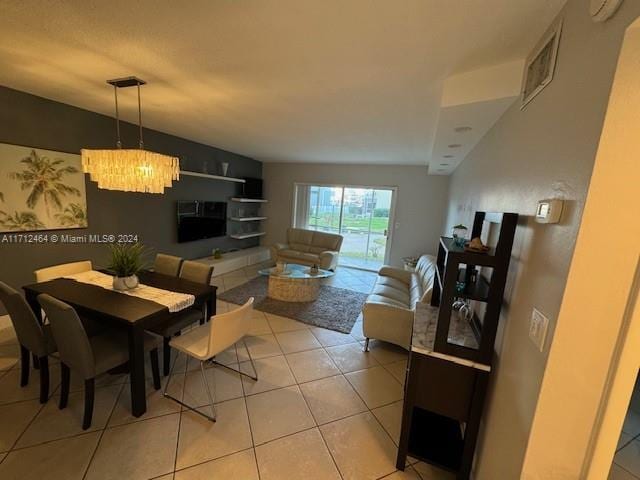 tiled dining area featuring an inviting chandelier