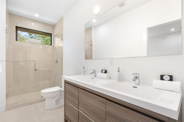 bathroom with tile patterned floors, toilet, vanity, and walk in shower