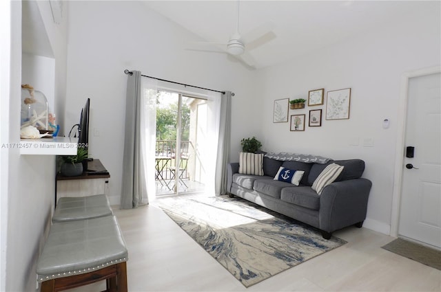 living room with ceiling fan and lofted ceiling