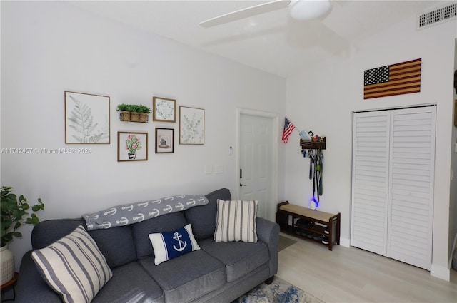 living room with ceiling fan and light wood-type flooring