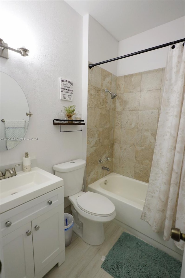 full bathroom featuring shower / tub combo, vanity, and toilet