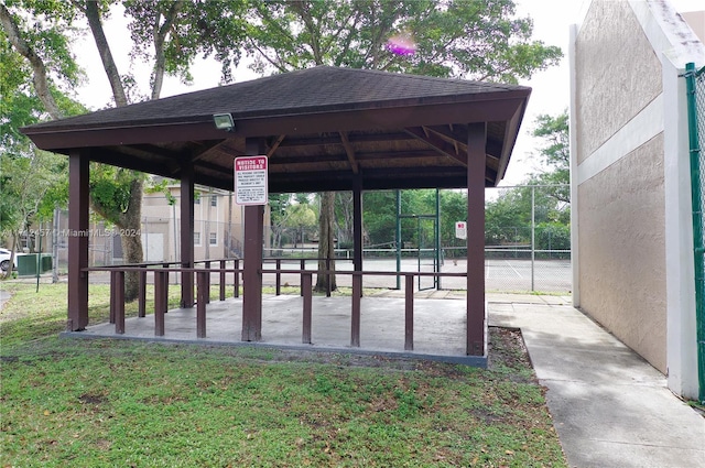 view of home's community featuring a gazebo, tennis court, and a yard