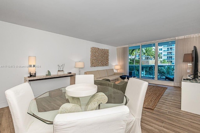 dining room with hardwood / wood-style flooring and floor to ceiling windows