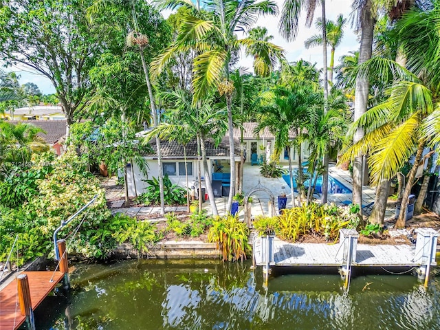 view of dock featuring a patio and a water view