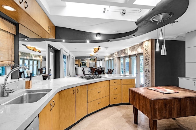 kitchen with sink, a healthy amount of sunlight, and stainless steel gas stovetop