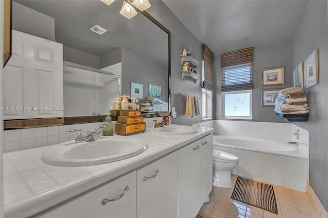 full bathroom featuring tile patterned floors, toilet, vanity, and shower with separate bathtub