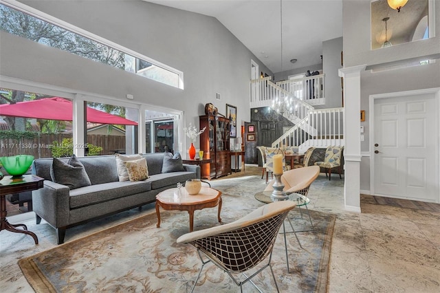 living room with high vaulted ceiling and a healthy amount of sunlight