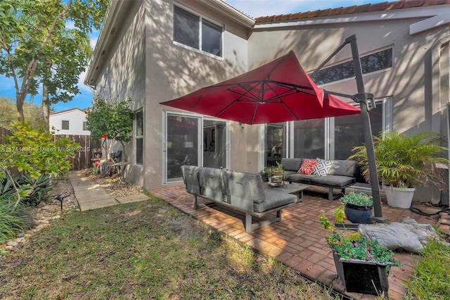 back of house with a patio and outdoor lounge area