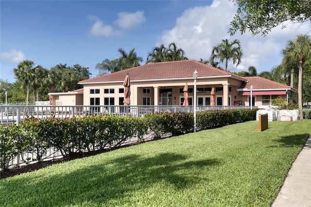 rear view of house featuring a yard