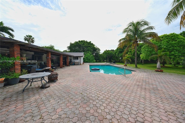 view of swimming pool featuring a patio area